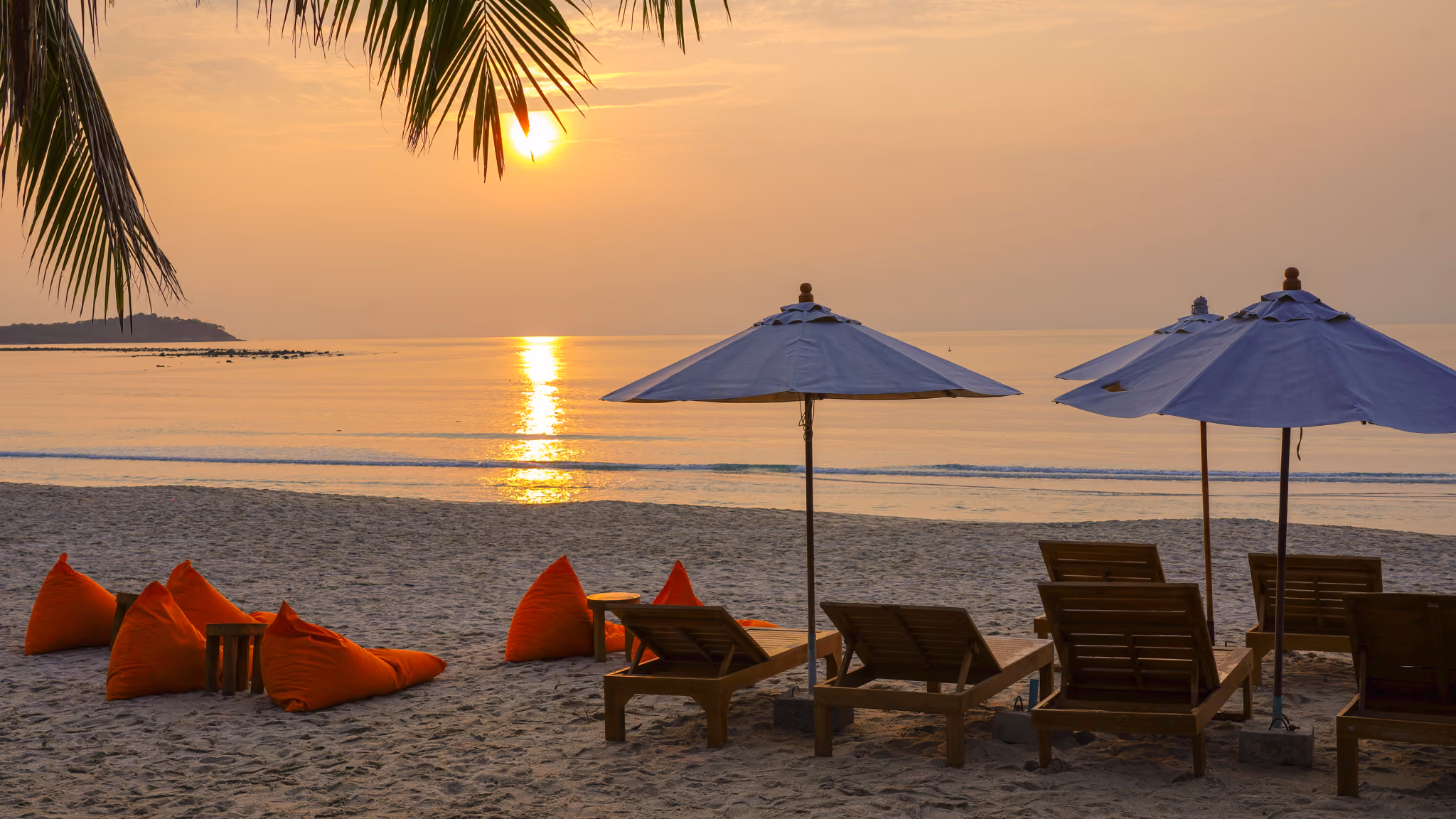 Sunrise over Chaweng Beach in front of the resort, with loungers and umbrellas on the sand